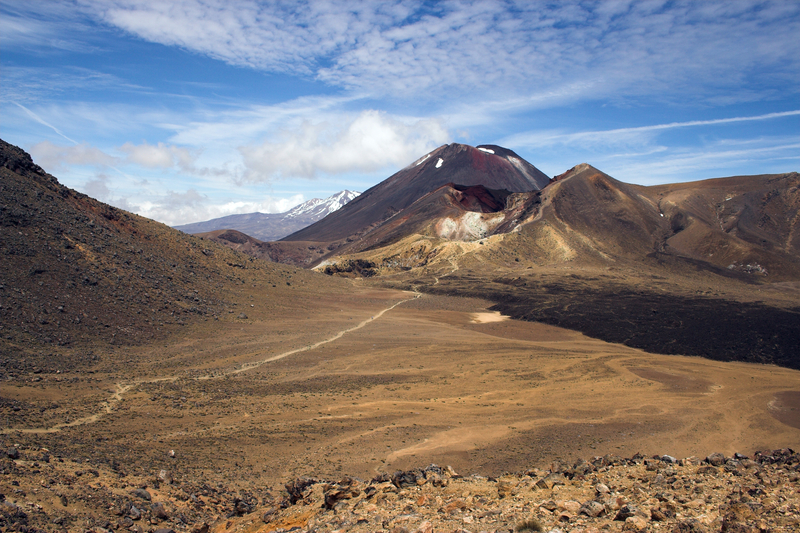 Image of barren landscape with a dirt path leading to a brown mountain