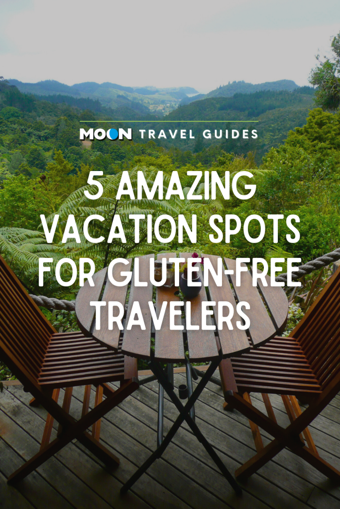 Outdoor cafe table and chairs overlooking rainforest with text 5 Amazing Vacation Spots for Gluten-Free Travelers