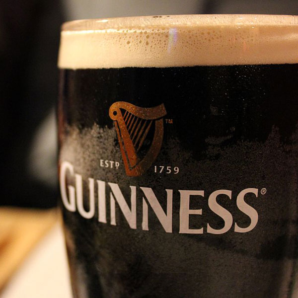 A Guinness dark Irish dry stout beer glass that originated in the