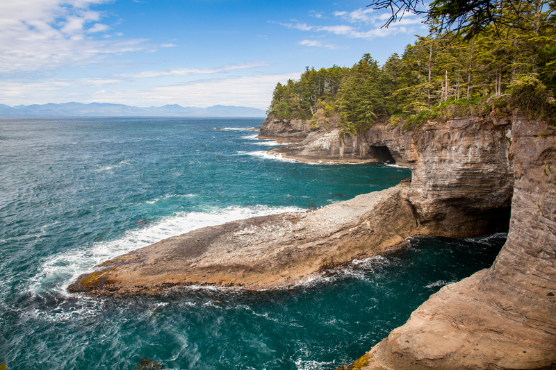 Viewpoint of turquoise ocean and rocky cliffs and coves.