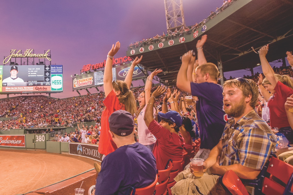 Fans raise their hands and cheer on the Red Sox