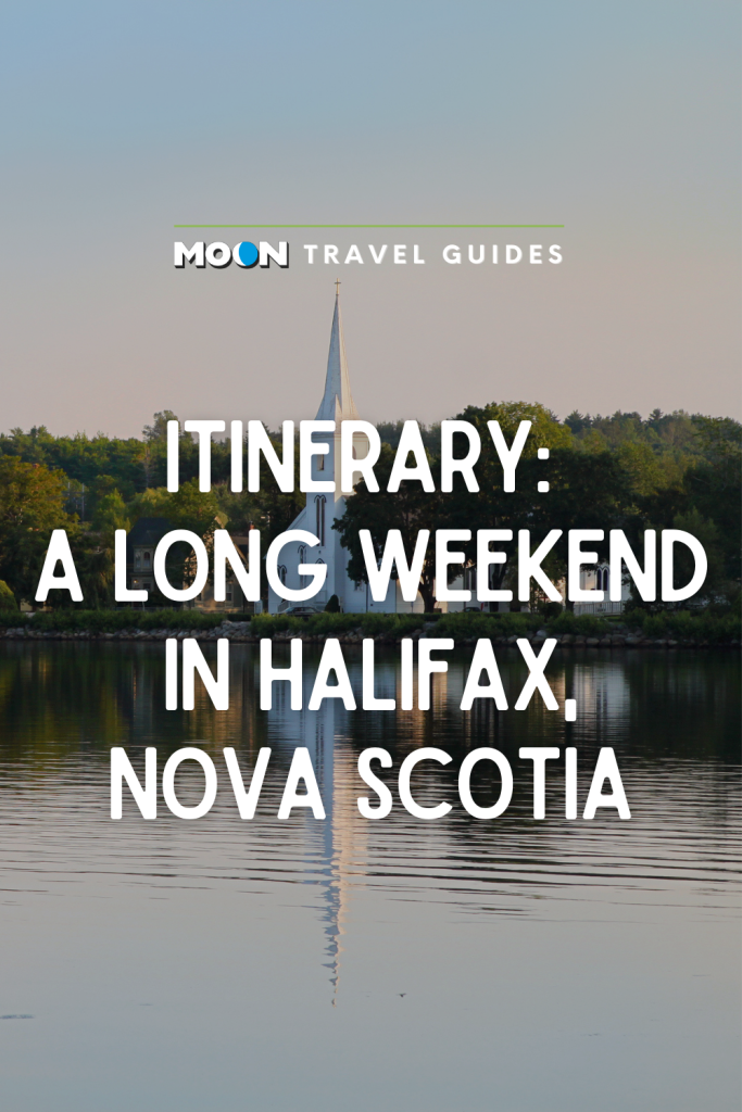 Image of white steepled church reflected in water with text Itinerary: A Long Weekend in Halifax, Nova Scotia