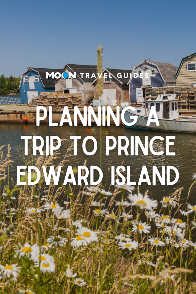 Image of boats docked alongside charming fishing shacks with text Planning a Trip to Prince Edward Island