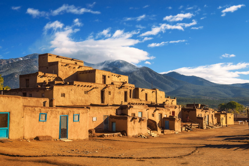 Image of brown adobe buildings under bright blue sky