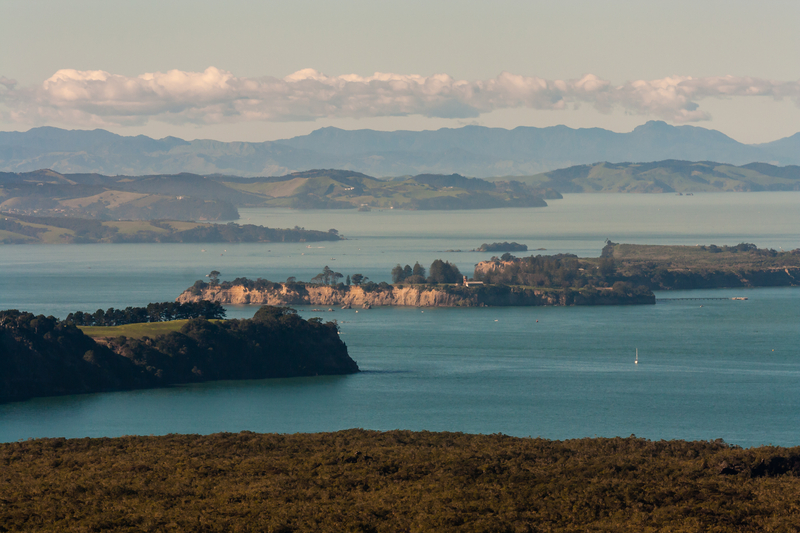 Image taken from high viewpoint of low islands gently illuminated by the setting sun.