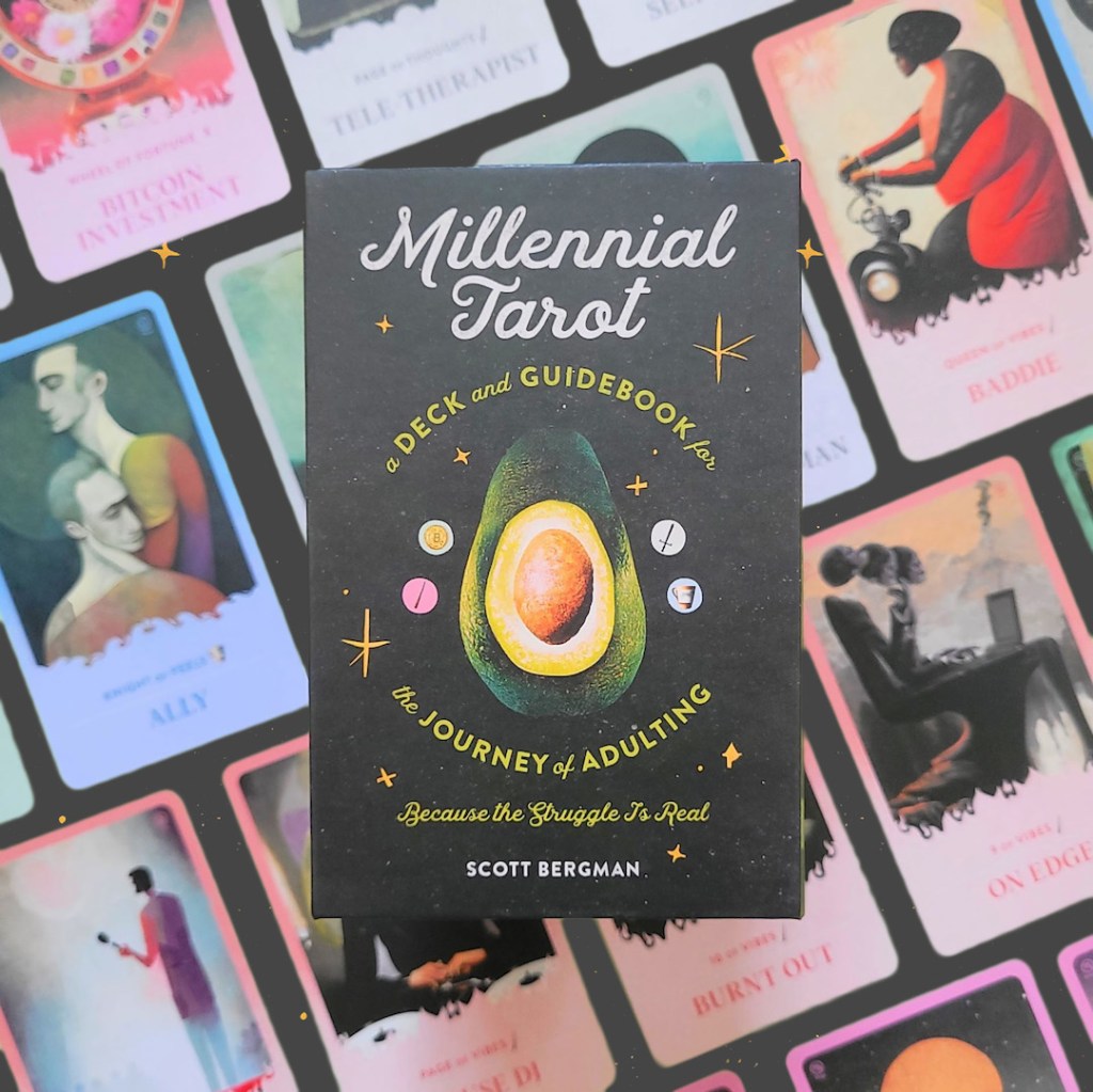 Photo of the “Millennial Tarot” box laid above face-up cards from the deck