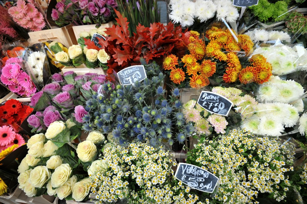 Bouquets of colorful flowers for sale at a market.