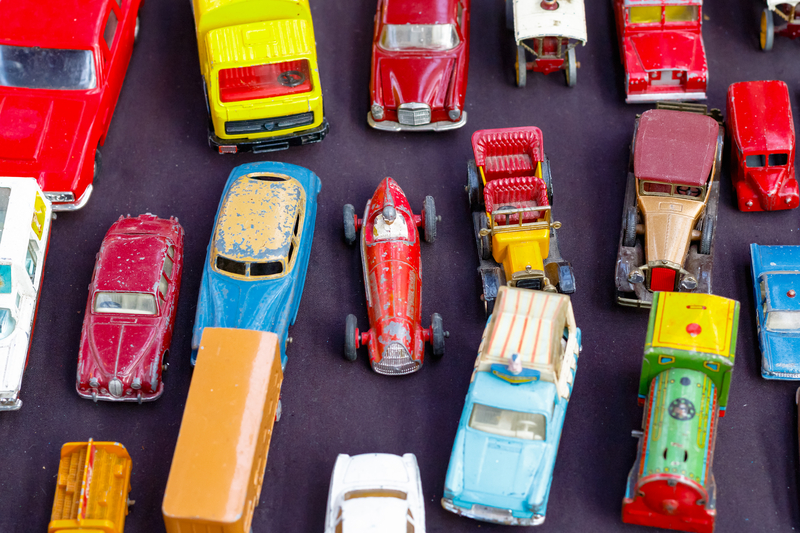 Colorful antique toy cars on a dark purple background