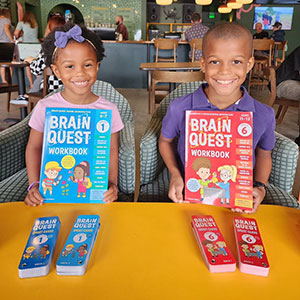 Image of children with Brain Quest workbooks.