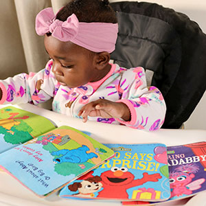 Image of toddler with picture books.