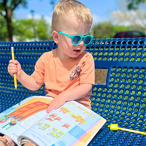 Child, 0-3 years old with a workbook.