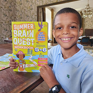 Child, 13-17 years old with a Brain Quest workbook.