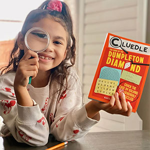 Child, 4-7 years old with a Cluedle book.